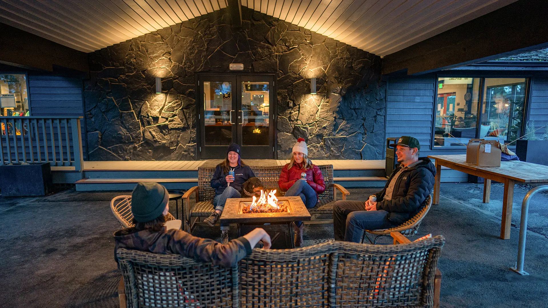 Group at a fire pit at the Trailhead Lodge